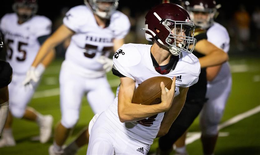 A football player runs the ball